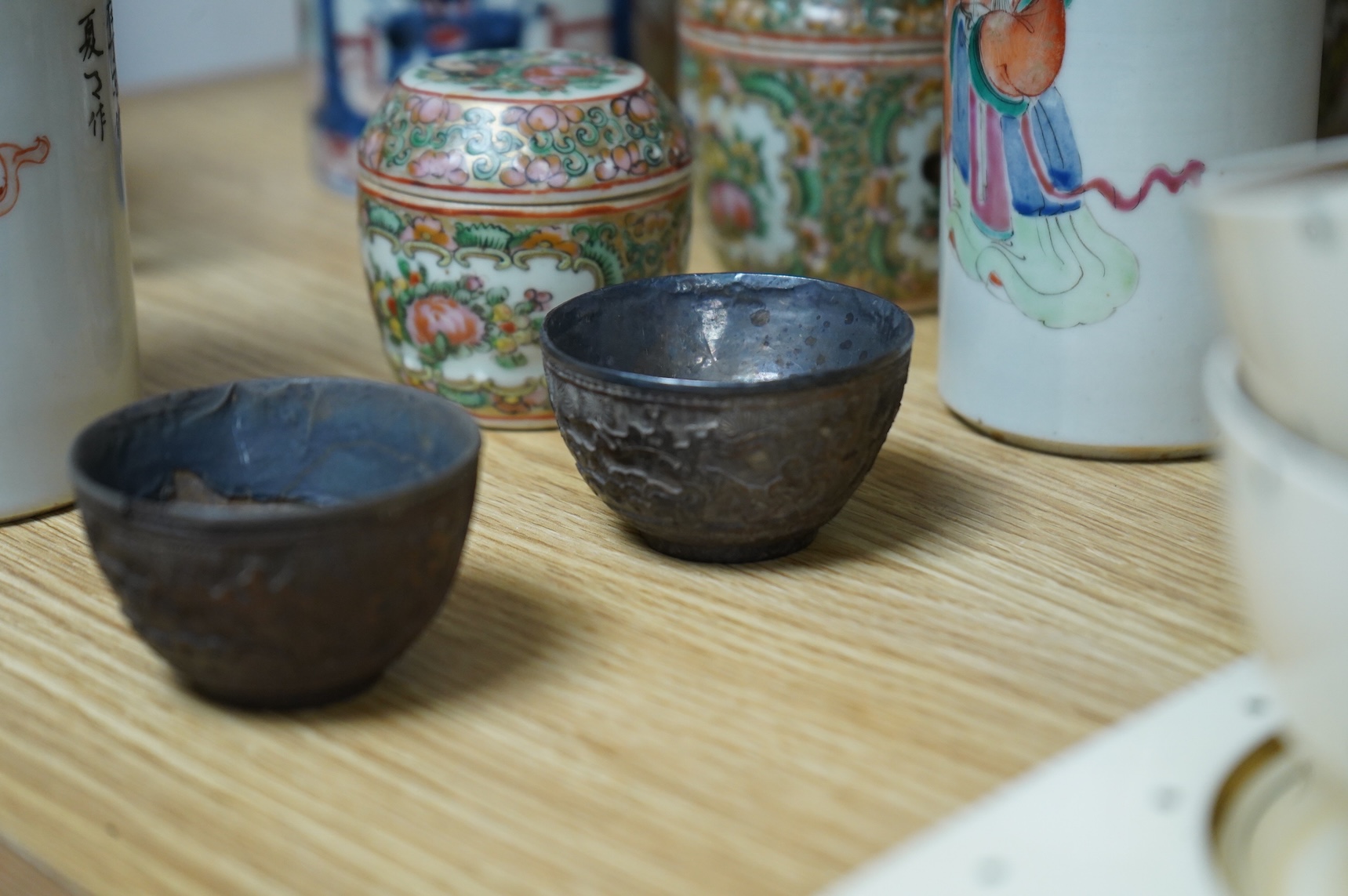 A collection of Chinese ceramics to include a blue and white mug, set of three graduated Canton jars and covers and two cylindrical brush washers